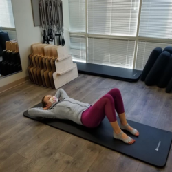 Instructor Demos a Pilates Chest Lift - First Position | Spine & Sport PT Rancho Santa Margarita Clinic