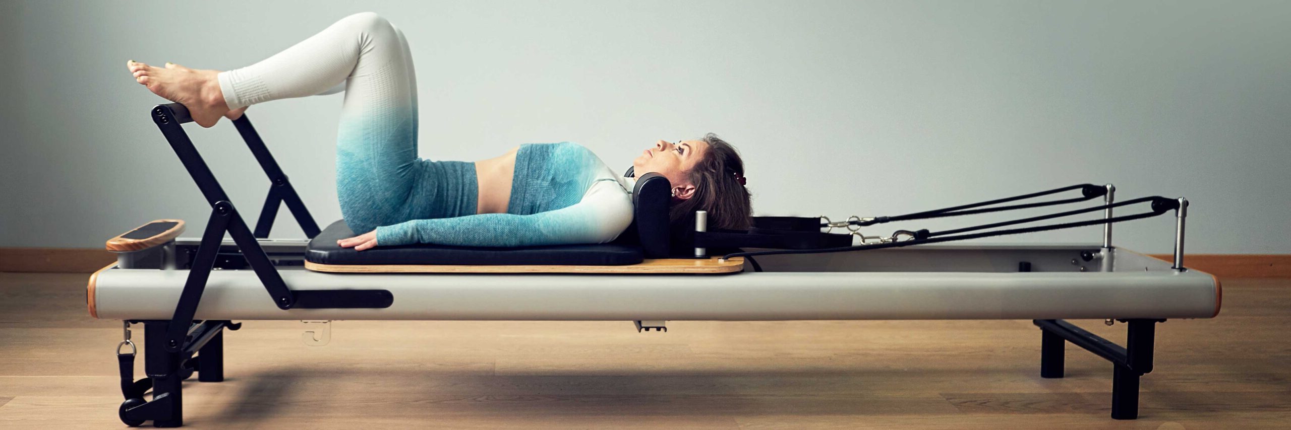 Pilates 101 participant on a Pilates machine | Spine & Sport Physical Therapy | Rancho Santa Margarita, CA