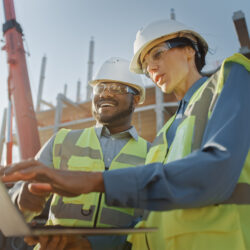 Workers at a construction site discussing workers' comp