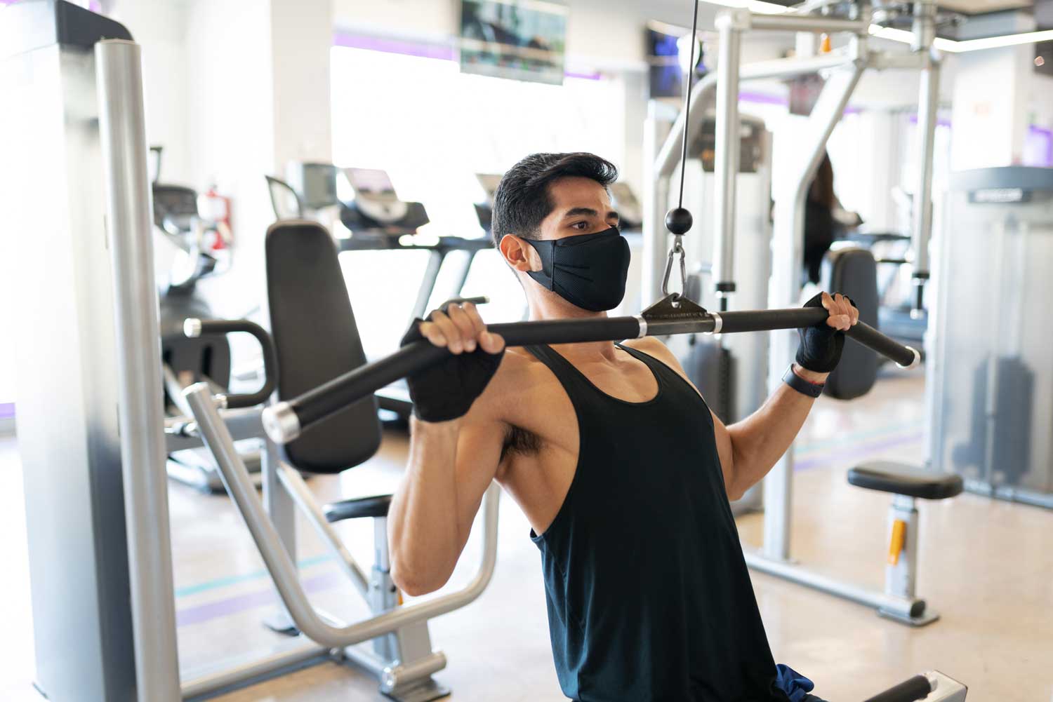 Man wearing mask at gym post Covid | Spine & Sport Physical Therapy | San Diego, Irvine, Sacramento, CA