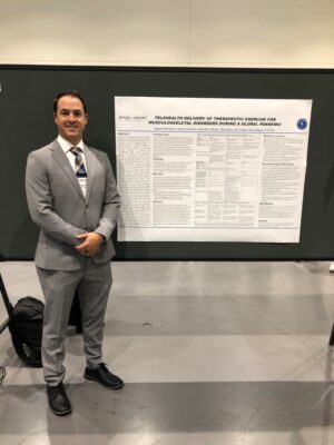 Daniel Mortimer standing next to his presentation on the physical therapy telehealth study | Spine & Sport Physical Therapy | San Diego and California locations